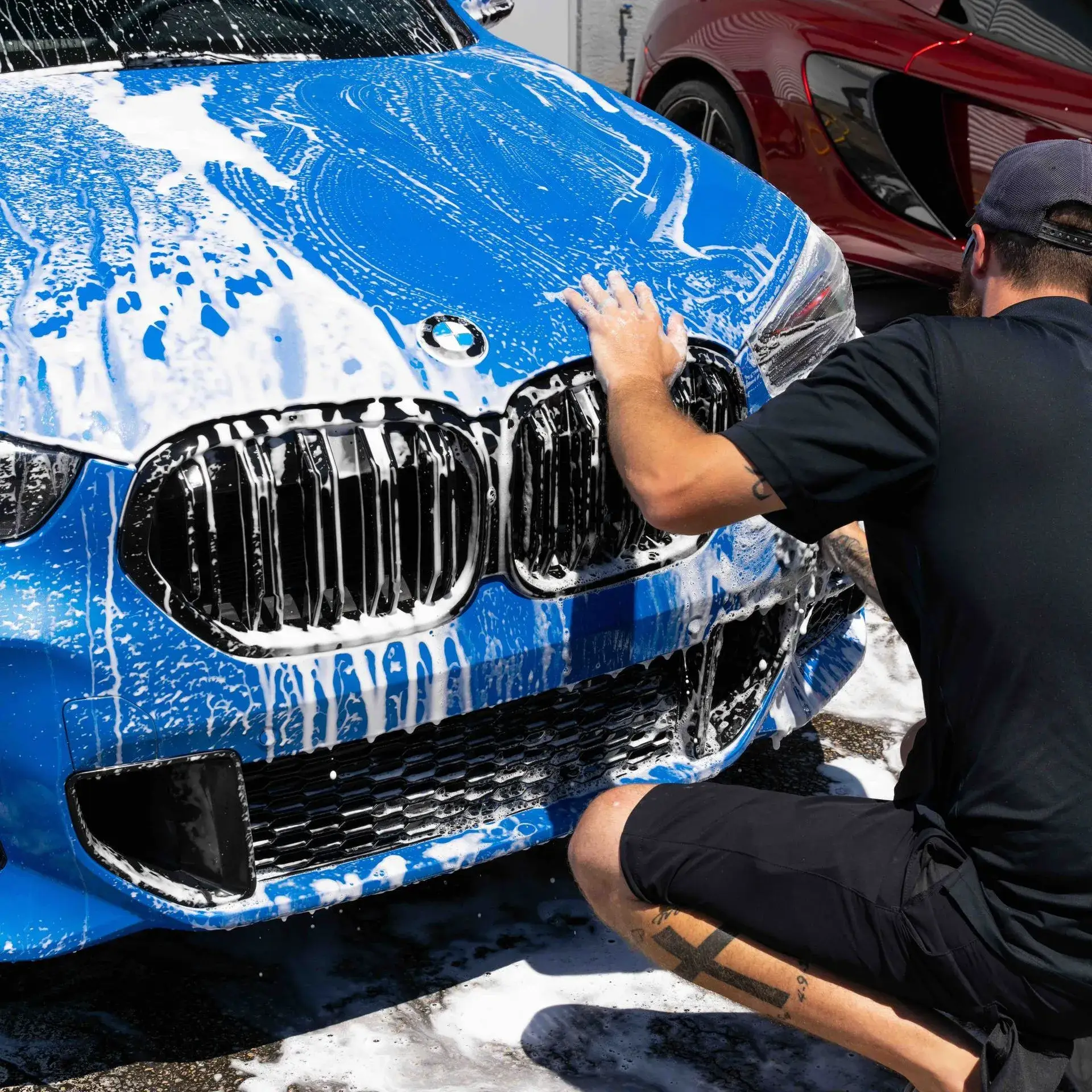 ST6 technician hand-washing a vehicle
