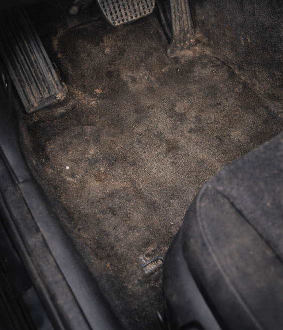 Driver floor carpet dirty before interior detailing Colorado Springs