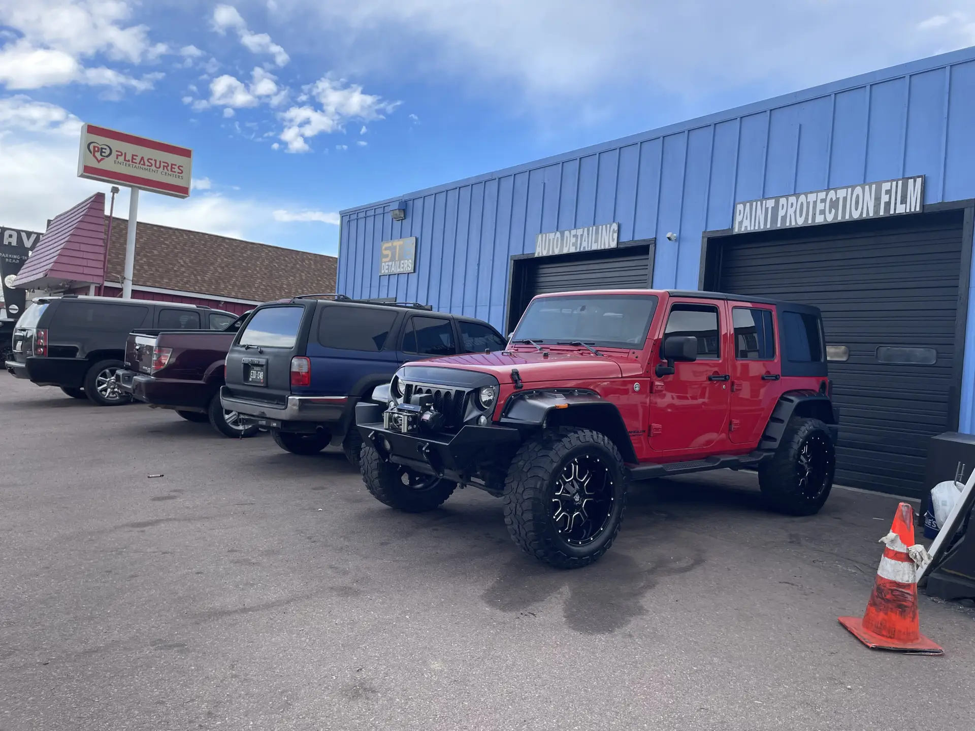 4 detailed vehicles lined up in front of ST6 Detailers shop, Colorado Springs