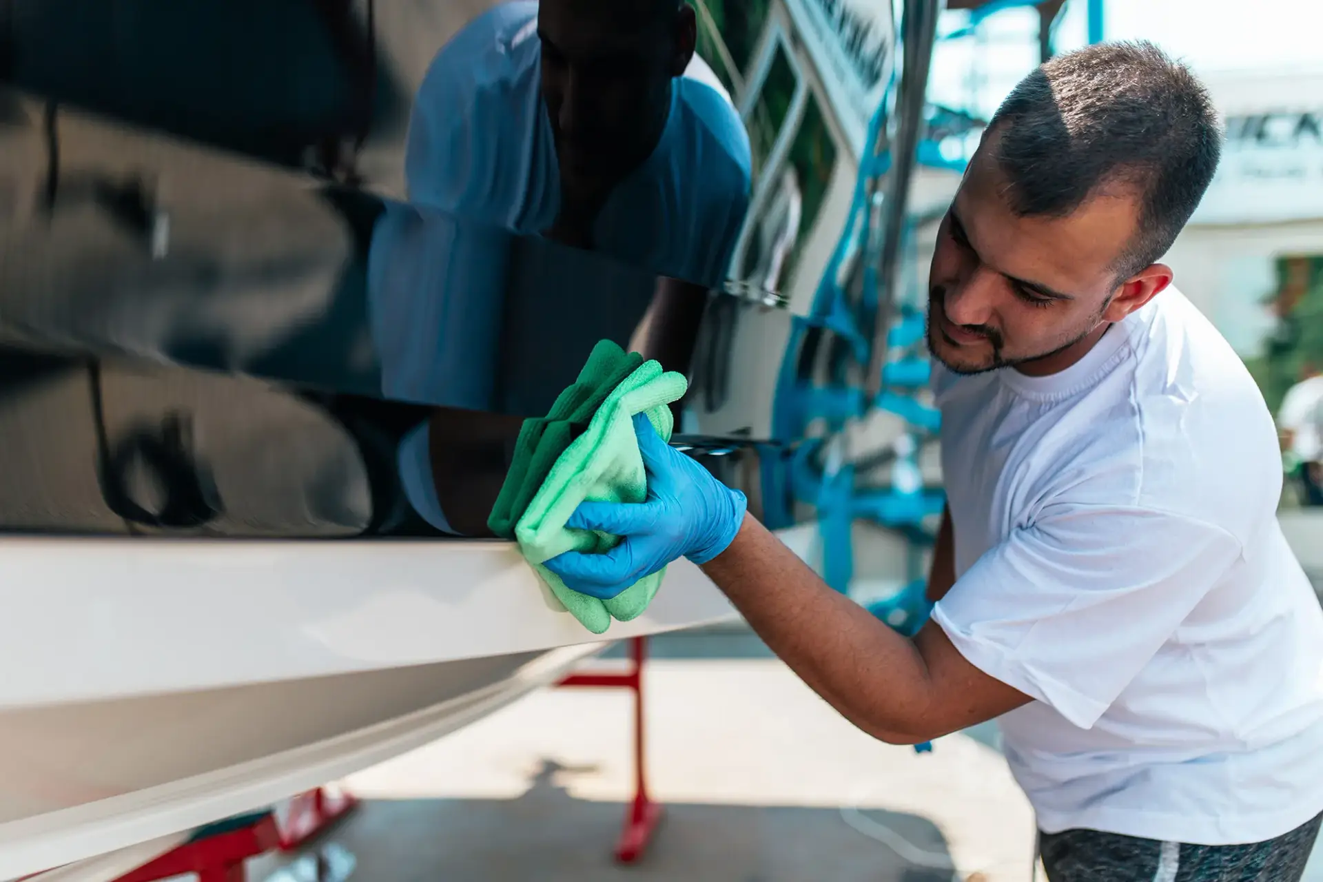 ST6 technician wiping down boat hull in Colorado Springs