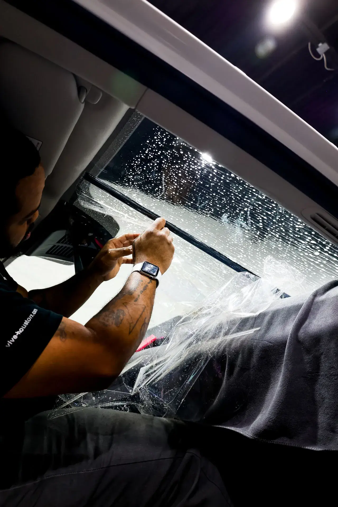 Windshield tint strip being installed at ST6 Detailers
