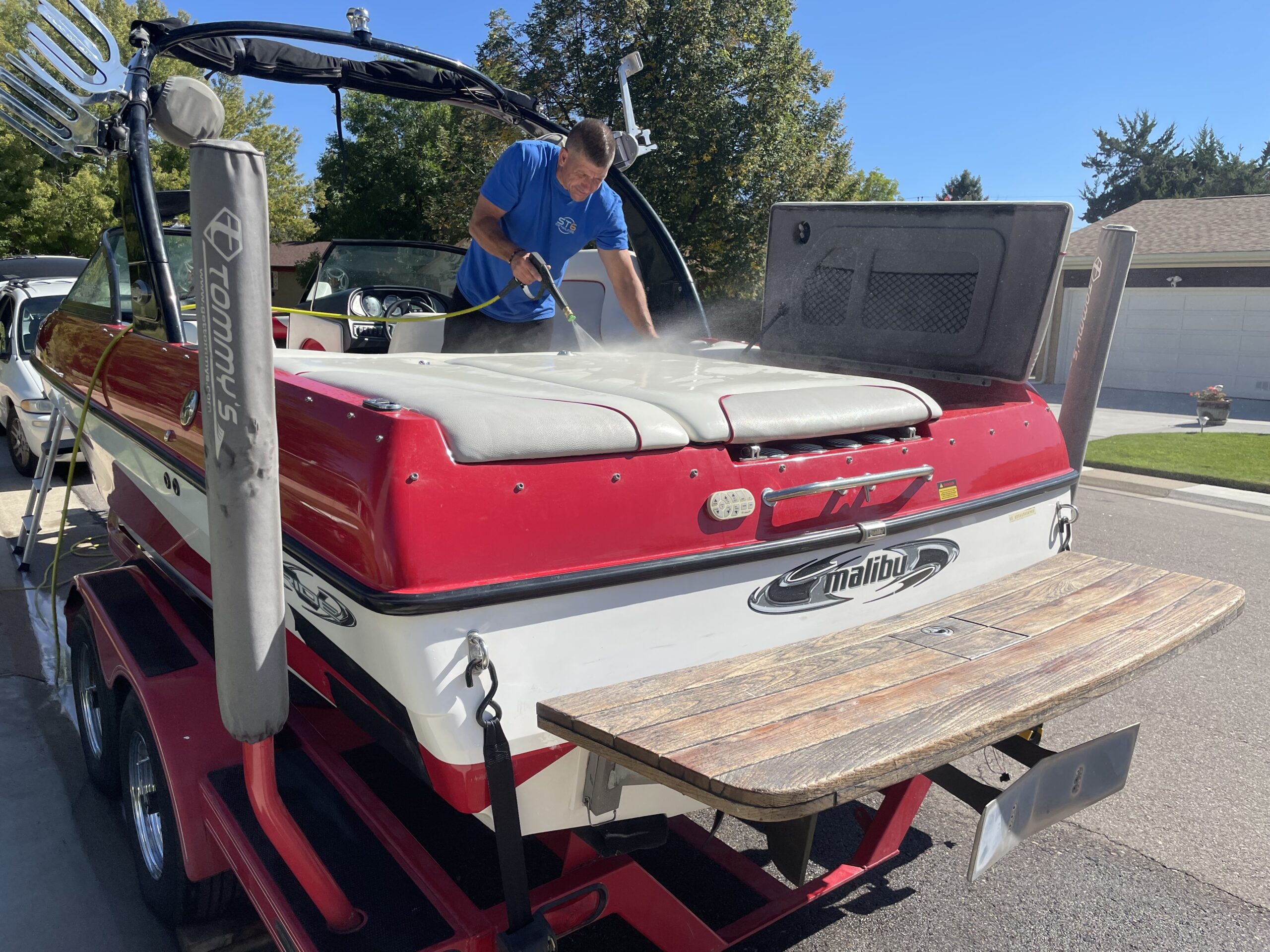 ST6 technician pressure washing and correcting boat interior during marine ceramic prep